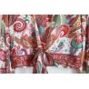 White wrap blouse with colorful pattern